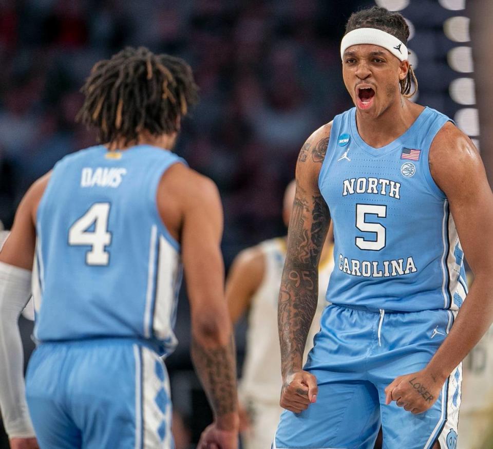 North Carolinas Armando Bacot (5) and R.J. Davis (4) react after a basket by Brady Manek to give the Tar Heels a commanding 56-38 lead over Baylor in the second half on Saturday, March 19, 2022 during the NCAA Tournament at Dickies Arena in Ft. Worth, TX.