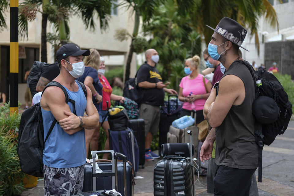 Tourists wait for transportation after sleeping in a shelter following the passing of Hurricane Delta in Cancun, Mexico, on October 7, 2020. / Credit: Victor Ruiz Garcia / AP