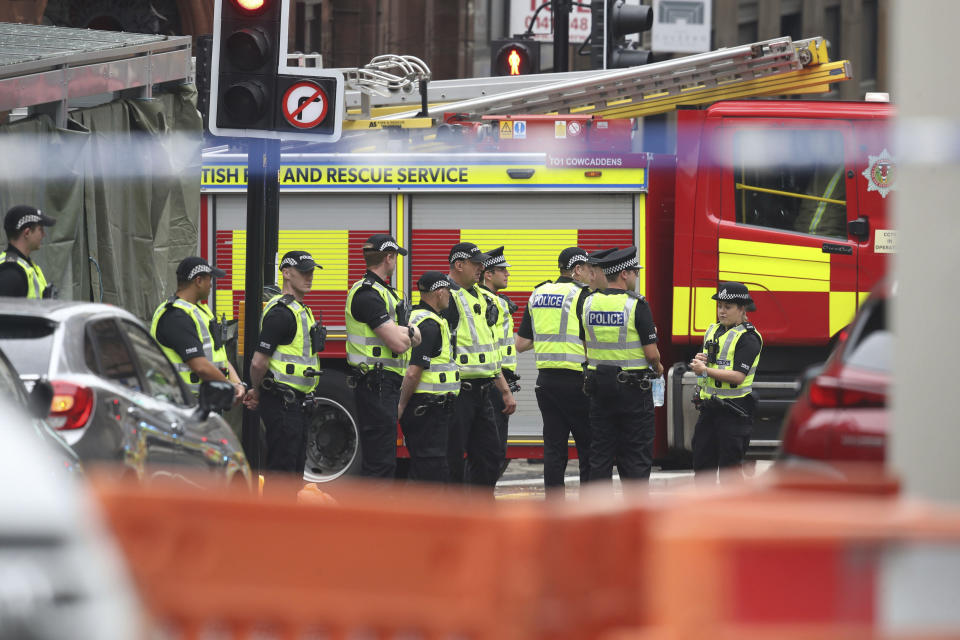 Emergency services attend the scene of an incident in Glasgow, Scotland, Friday June 26, 2020. Police in Glasgow say emergency services are currently dealing with an incident in the center of Scotland's largest city and are urging people to avoid the area. (Andrew Milligan/PA via AP)