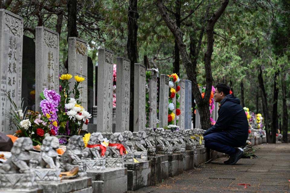 A man visits the tomb of deceased relatives during the annual Tomb-Sweeping festival, also known as the Qingming festival, at Babaoshan Cemetery in Beijing on April 5, 2023.