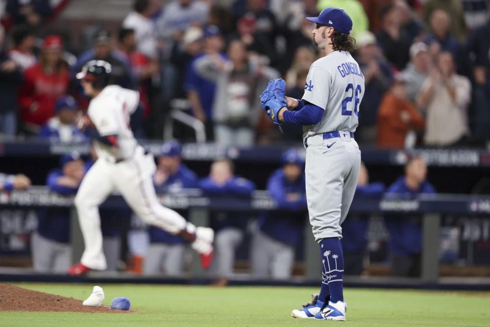 Dodgers starting pitcher Tony Gonsolin reacts while Braves' Austin Riley rounds the bases off a solo home run