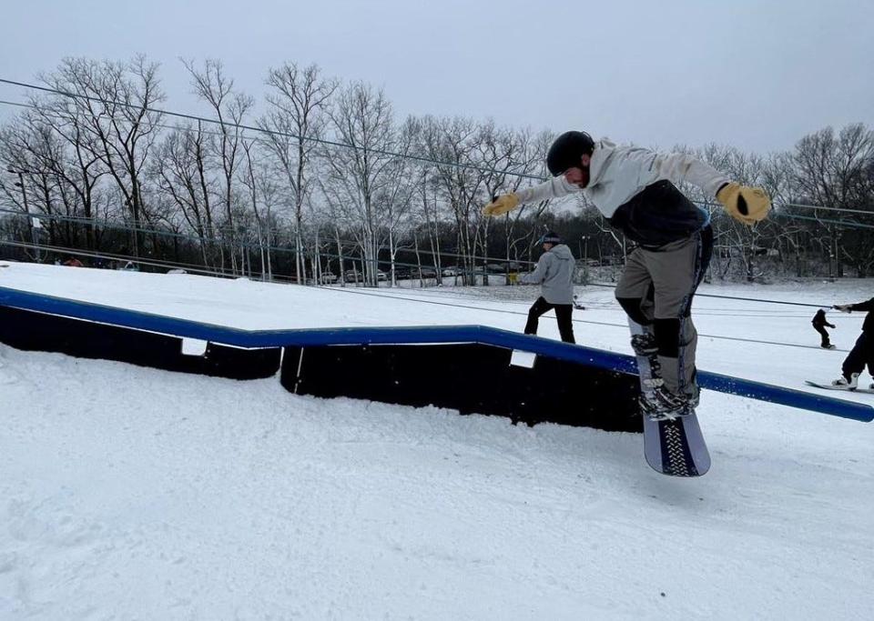 A snowboarder rides a rail in a small terrain park last weekend at Swiss Valley Ski & Snowboard Area in Jones.