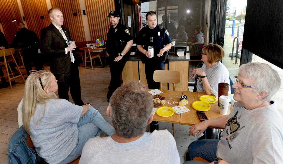 Springfield police Detective Tim Zajicek, officer Andy Barnes and officer Chris Jones (back, left to right) have coffee and talk with residents Thursday at the Starbucks on Dirksen Parkway. [Thomas J. Turney/The State Journal-Register]