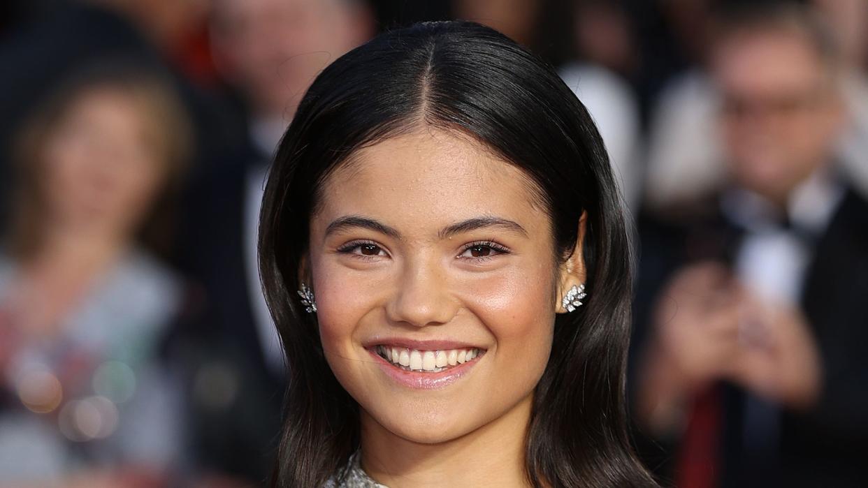 woman in white dress at film premiere