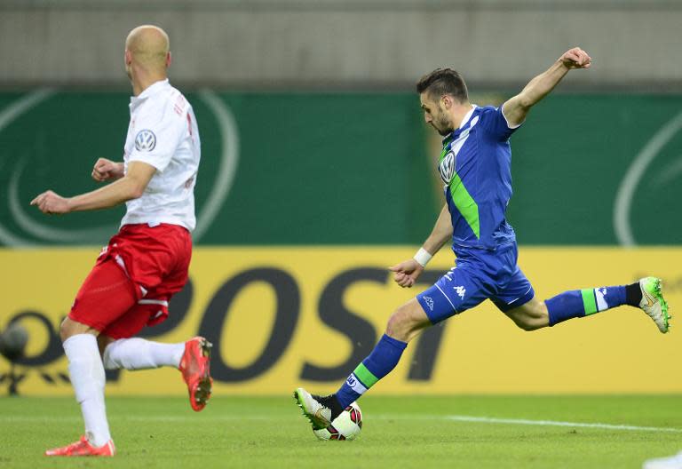 Wolfsburg's midfielder Daniel Caligiuri (R) scores a goal next to Leipzig's defender Tim Sebastian during their German football Cup DFB Pokal round of 16 match in Leipzig, Germany, on March 4, 2015 +++ RESTRICTIONS / EMBARGO – ACCORDING TO DFB RULES IMAGE SEQUENCES TO SIMULATE VIDEO IS NOT ALLOWED DURING MATCH TIME. MOBILE (MMS) USE IS NOT ALLOWED DURING AND FOR FURTHER TWO HOURS AFTER THE MATCH. FOR MORE INFORMATION CONTACT DFB DIRECTLY AT +49 69 67880