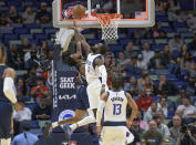 New Orleans Pelicans guard Nickeil Alexander-Walker (6) cannot get a shot off at the buzzer against Dallas Mavericks forward Tim Hardaway Jr. (11) in the first half of an NBA basketball game in New Orleans, Wednesday, Dec. 1, 2021. (AP Photo/Matthew Hinton)