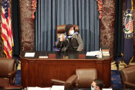 WASHINGTON, DC - JANUARY 06: A protester sits in the Senate Chamber on January 06, 2021 in Washington, DC. Congress held a joint session today to ratify President-elect Joe Biden's 306-232 Electoral College win over President Donald Trump. Pro-Trump protesters have entered the U.S. Capitol building after mass demonstrations in the nation's capital. (Photo by Win McNamee/Getty Images)