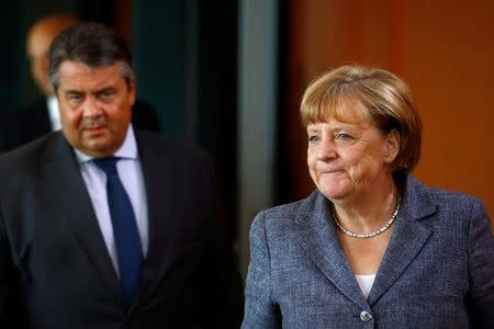 German Economy Minister Sigmar Gabriel and German Chancellor Angela Merkel (R) attend the cabinet meeting at the Chancellery in Berlin, Germany, August 17, 2016. REUTERS/Axel Schmidt