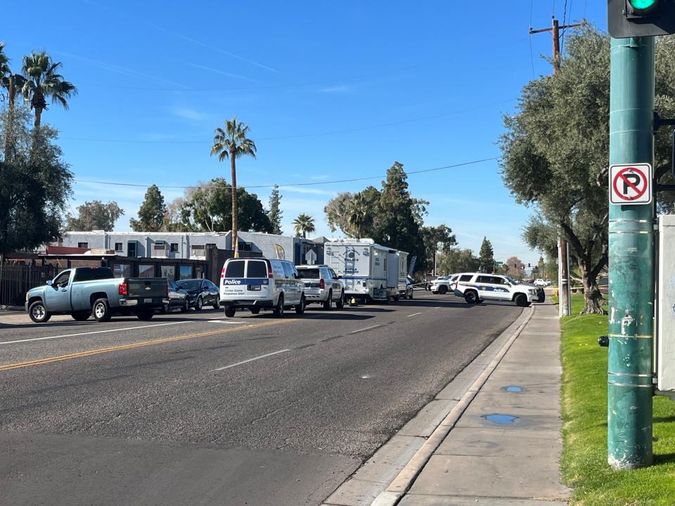 Phoenix police personnel on Dec. 15, 2023, are parked outside the Missouri Crossing apartment complex during an investigation of an overnight shooting that left one woman dead