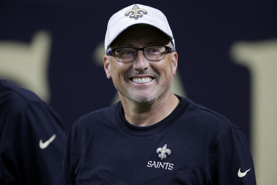 FILE -N ew Orleans Saints offensive coordinator Pete Carmichael smiles before an NFL football game against the Los Angeles Chargers in New Orleans, Friday, Aug. 26, 2022. For all but one year since 2006, recently retired Saints coach Sean Payton has overseen the offensive game plan and has usually called plays on game days. This weekend in Atlanta, the Saints debut an offense now run exclusively by long-time Payton understudy Pete Carmichael Jr. (AP Photo/Derick Hingle, File)