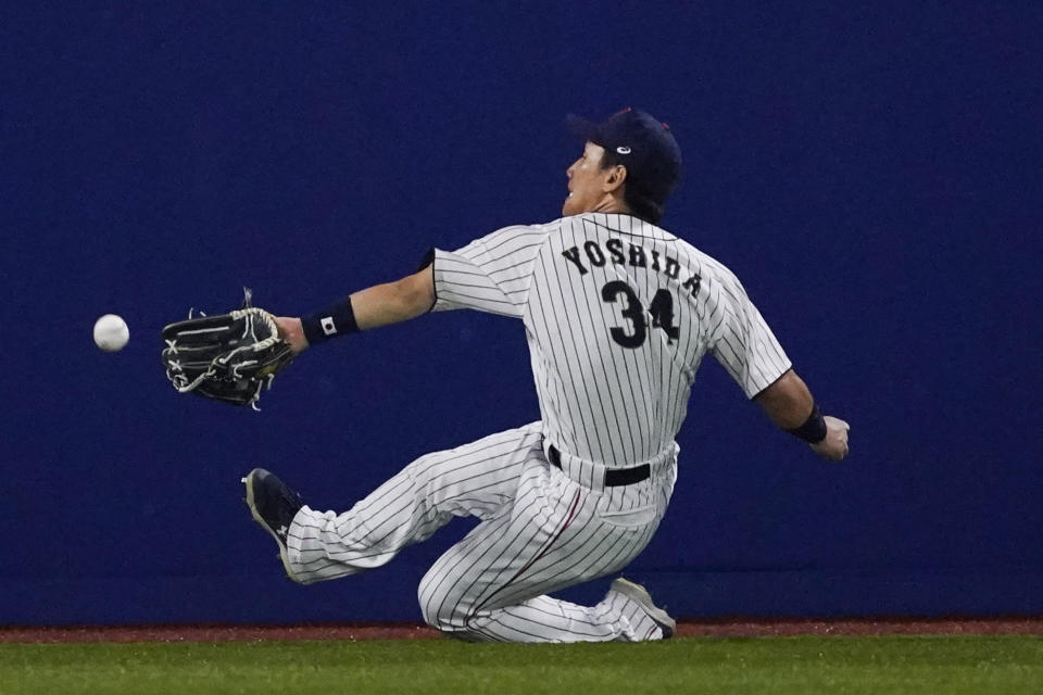 FILE - Japan's Masataka Yoshida cannot reach a ball hit by United States' Triston Casas during the seventh inning of a baseball game at the 2020 Summer Olympics, Aug. 2, 2021, in Yokohama, Japan. Two Japanese rookies, New York Mets pitcher Kodai Senga and Boston Red Sox outfielder Masataka Yoshida, are worth watching in 2023. (AP Photo/Sue Ogrocki, File)