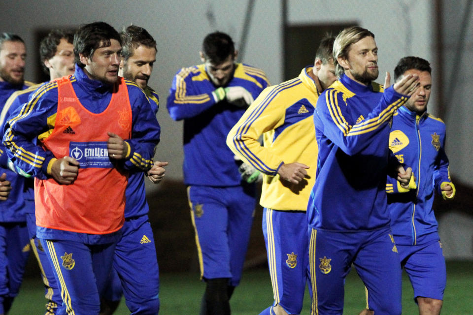 Ukrainian national soccer team players warm up during a training session at the Ayia Napa resort, southeastern Cyprus, Thursday, March 4, 2014. Ukraine will face the United States in a friendly soccer match on Wednesday in Cyprus, after the match was moved from Kharkiv, Ukraine to Larnaca for security reasons. (AP Photo/Petros Karadjias)