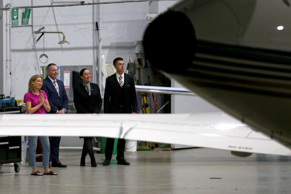 Shane Warne's personal assistant Helen Nolan, pictured here with airport officials as Shane Warne's body arrives at Melbourne airport.