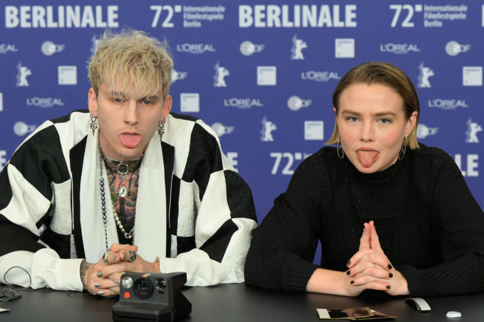 Colson sticking his tongue out as he sits next to an actress, who's also sticking her tongue out, at the Berlinale film festival