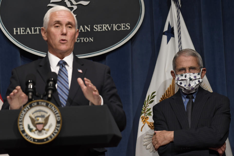 FILE - In this June 26, 2020, file photo, Dr. Anthony Fauci, right, director of the National Institute of Allergy and Infectious Diseases, listens as Vice President Mike Pence speaks during a news conference with the Coronavirus task force at the Department of Health and Human Services in Washington. As the public face of the administration's coronavirus response. Vice President Mike Pence has been trying to convince Americans that the country is winning even as cases spike in large parts of the country. For public health experts, that sense of optimism is detached from reality. (AP Photo/Susan Walsh, File)