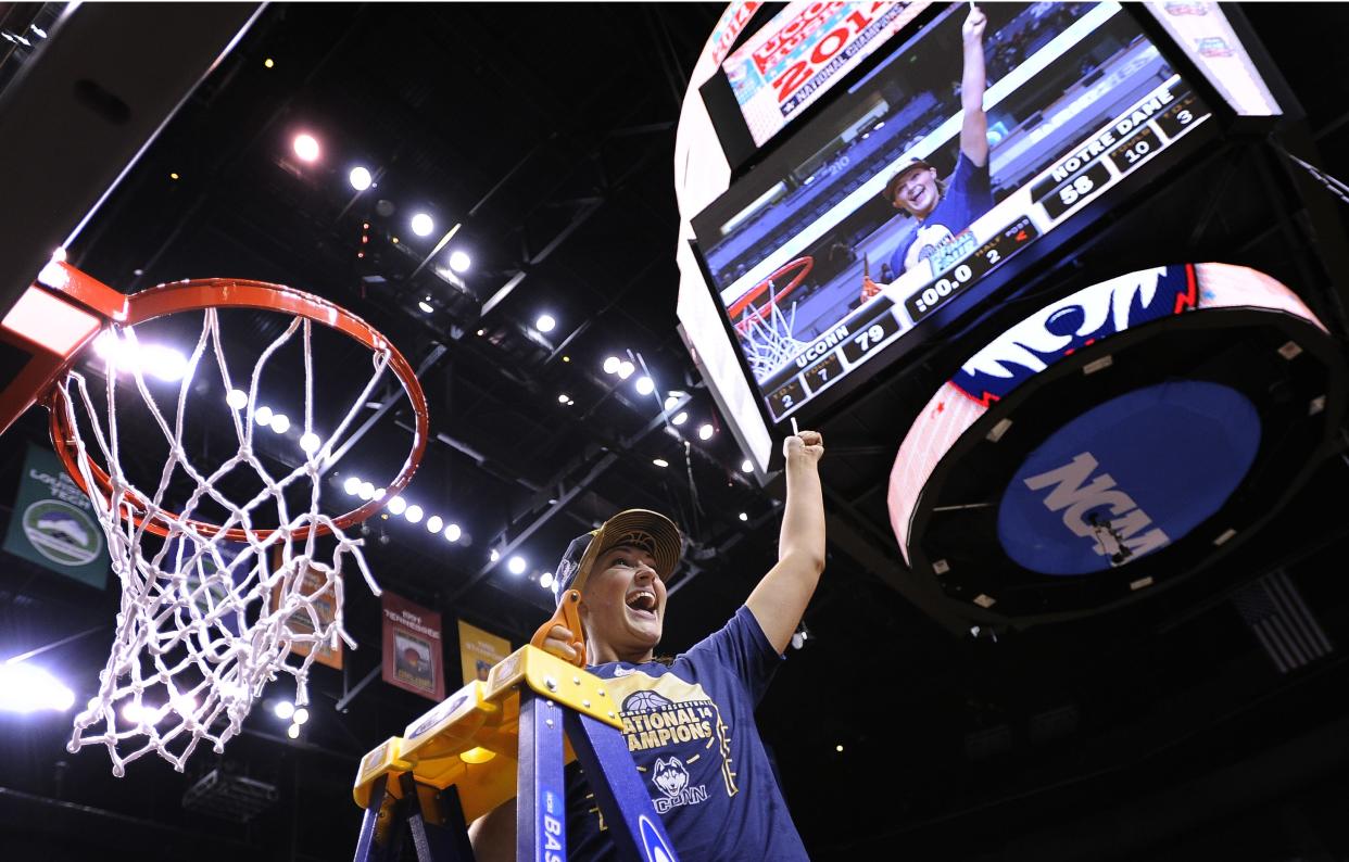 Connecticut Huskies center Stefanie Dolson (31) celebrates after cutting off a piece of the net after the second half of the championship game against Notre Dame in the Final Four of the NCAA women's college basketball tournament, Tuesday, April 8, 2014, in Nashville, Tenn. Connecticut won 79-58.