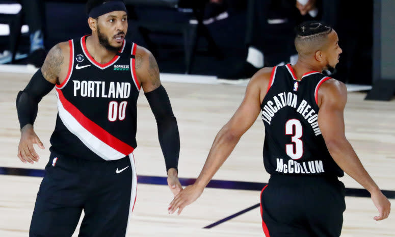 Carmelo Anthony #00 of the Portland Trail Blazers celebrates with CJ McCollum #3