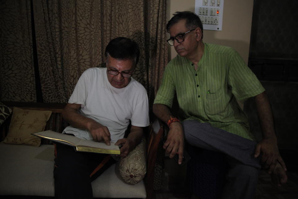 In this Aug. 21, 2019, photo, Kashmiri Hindu man Vijay Kaul, right, sits with his neighbor Ashok Bhatt, at his residence in New Delhi, India as he recites lines from a poem he wrote in 2015 when Kaul visited his ancestral home near Srinagar in Indian-administered Kashmir. Hundreds of thousands Kashmiri Hindus fled from their homes in late 80’s and early 90’s when separatist insurgency started targeting and killing Indian government officials, security forces, and eventually Kashmiri Hindus. Nearly 30 years after their exodus, the ghost of insurgency still haunts many Kashmiri Hindus. (AP Photo/Rishabh R. Jain.)