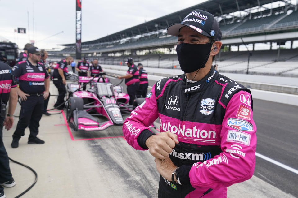 Helio Castroneves, of Brazil, waits in the pits before a practice session for a IndyCar auto race at Indianapolis Motor Speedway, Friday, Aug. 13, 2021, in Indianapolis. (AP Photo/Darron Cummings)