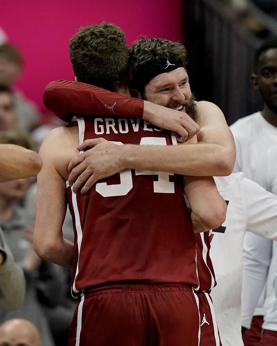 Oklahoma forwards Tanner Groves, facing camera, hugs forward Jacob Groves (34) during the second half of an NCAA college basketball game against Baylor in the quarterfinal round of the Big 12 Conference tournament in Kansas City, Mo., Thursday, March 10, 2022. Oklahoma won 72-67.