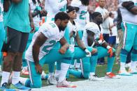 <p>(L-R) Arian Foster #29, Kenny Stills #10 and Michael Thomas #31 of the Miami Dolphins kneel during the national anthem before the game against the New England Patriots at Gillette Stadium on September 18, 2016 in Foxboro, Massachusetts. (Photo by Maddie Meyer/Getty Images) </p>