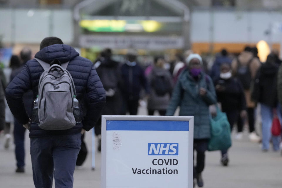 People queue for their vaccination at St Thomas' Hospital in London, Wednesday, Dec. 15, 2021. Long lines have formed for booster shots across England as the U.K. government urged all adults to protect themselves against the omicron variant. (AP Photo/Frank Augstein)