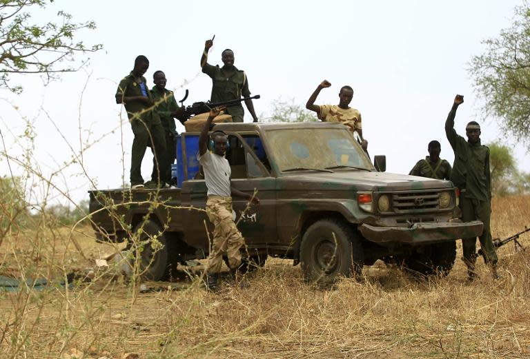 Sudanese Armed Forces celebrate after recapturing the Daldako area, northeast of South Kordofan's state capital Kadugli, on May 20, 2014