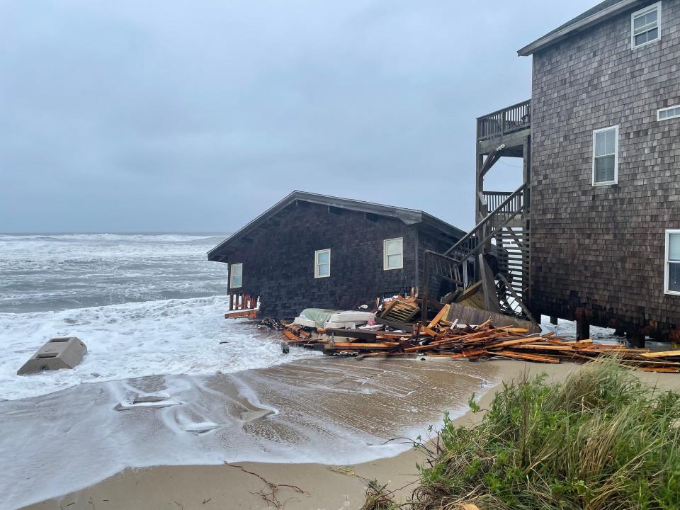 A collapsed house is seen along the shore in Rodanthe, North Carolina.