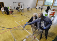 Voters cast their ballots shortly after polling stations open in Poland's tight presidential election runoff between conservative incumbent President Andrzej Duda and liberal Warsaw Mayor Rafal Trzaskowski in Lomianki, near Warsaw, Poland, on Sunday, July 12, 2020. Latest polls showed that the race may be decided by a very small margin. (AP Photo/Czarek Sokolowski)