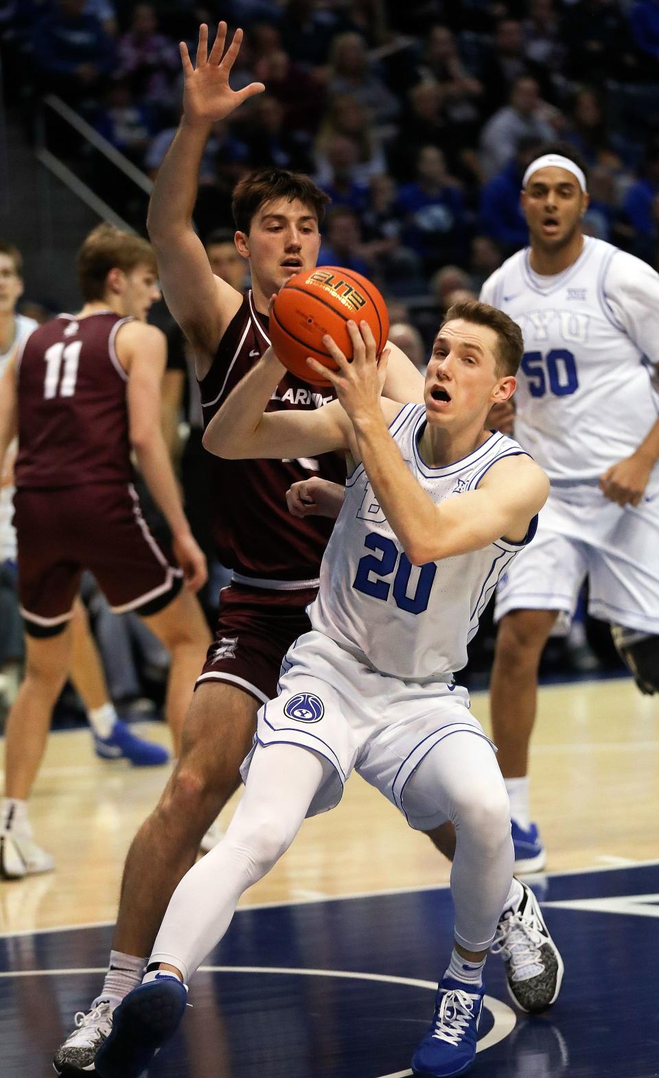 Brigham Young Cougars guard Spencer Johnson (20) looks to make a pass around Bellarmine Knights forward Langdon Hatton (12) during a men’s basketball game at the Marriott Center in Provo on Friday, Dec. 22, 2023. BYU won 101-59. | Kristin Murphy, Deseret News