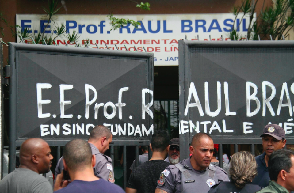 <em>Police officers guard the entrance of the Raul Brasil State School (AP)</em>