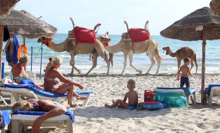 FILE PHOTO: Tourists relax on a beach on the island of Djerba, Tunisia, September 7, 2016. REUTERS/Zoubeir Souissi/File Photo