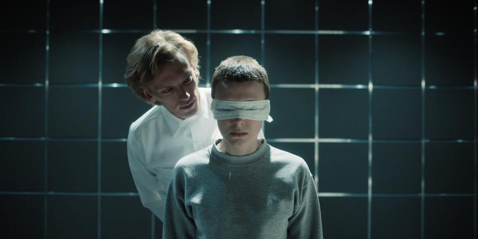 eleven with a blindfold while one stands behind her