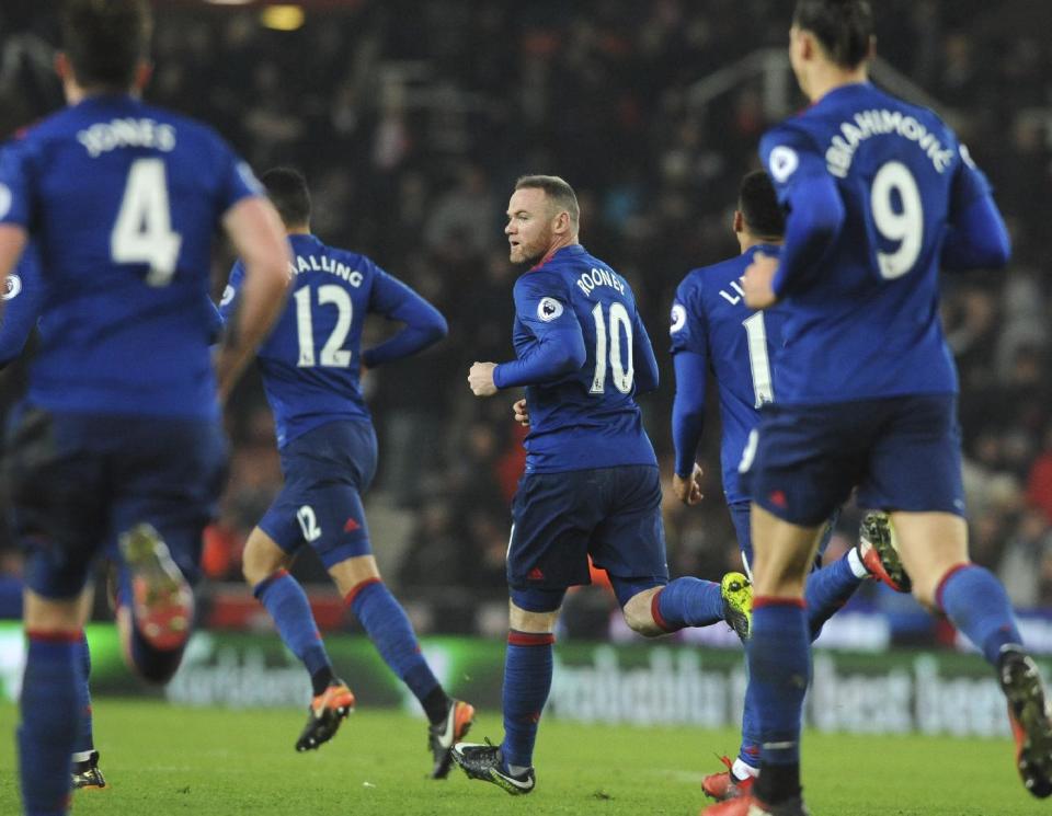 Manchester United's Wayne Rooney, centre, celebrates after scoring from a free kick during the English Premier League soccer match between Stoke City and Manchester United at the Britannia Stadium, Stoke on Trent, England, Saturday, Jan. 21, 2017. (AP Photo/Rui Vieira)