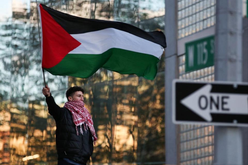 A man waves a Palestinian flag as pro-Palestinian activists protest outside Columbia University in New York City on April 20, 2024. (AFP via Getty Images)