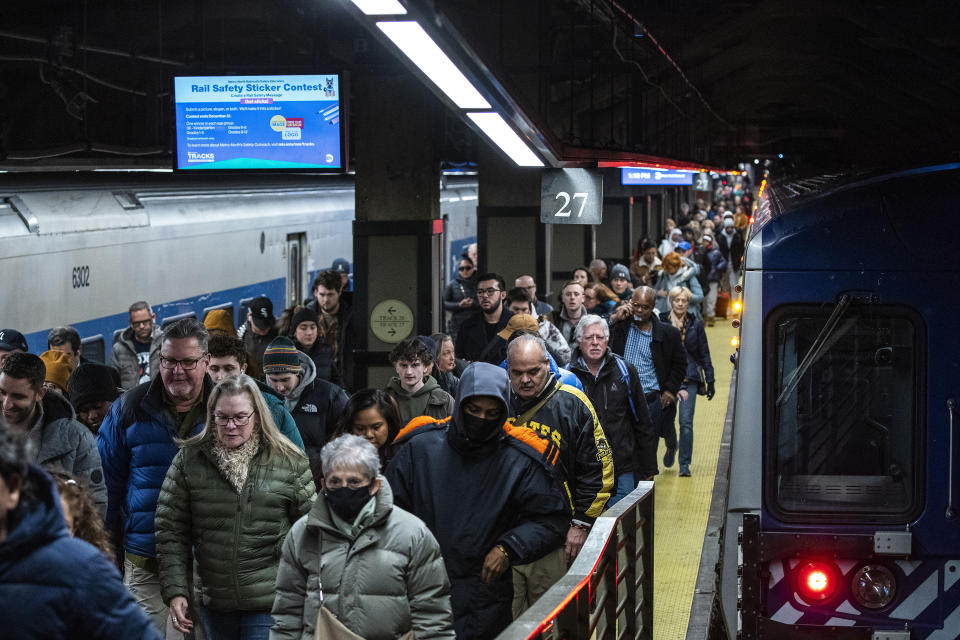 Travelers walk along the platform as they arrive at Grand Central Station in New York, Thursday, Dec. 21, 2023. (AP Photo/Eduardo Munoz Alvarez)