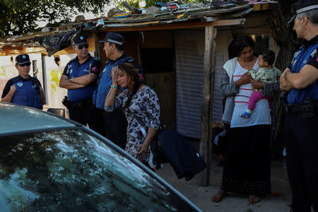 Veronica Radu, 24, reacts as she leaves the Roma shanty town of El Gallinero, on the outskirts of Madrid, Spain, September 27, 2018. REUTERS/Susana Vera