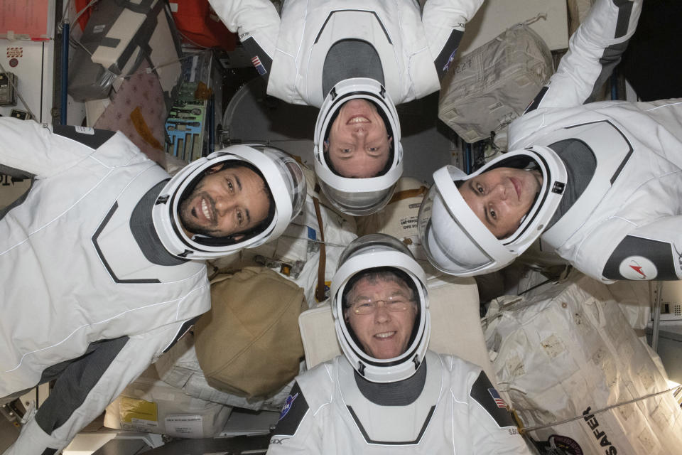 In this May 2023 photo provided by NASA, clockwise from bottom, NASA astronaut Stephen Bowen, United Arab Emirates astronaut Sultan al-Neyadi, NASA astronaut Warren (Woody) Hoburg and Roscosmos cosmonaut Andrey Fedyaev pose for a portrait in their pressure suits aboard the International Space Station. The astronauts are back on Earth after a six-month stay at the International Space Station. Their SpaceX capsule parachuted into the Atlantic early Monday, Sept. 4, off the Florida coast. (NASA via AP)