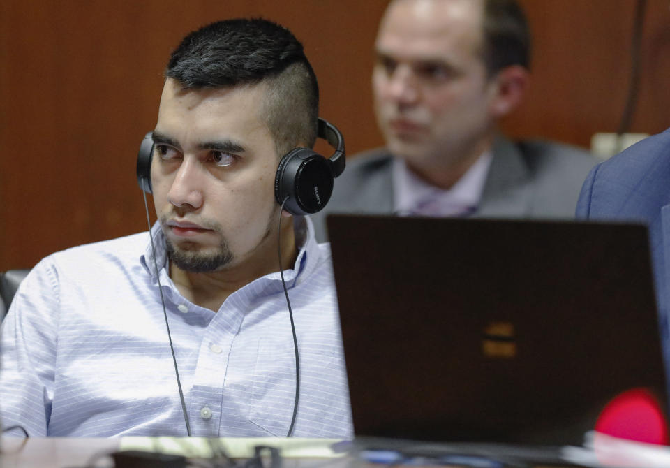 Cristhian Bahena Rivera listens to testimony that has been translated into Spanish by an interpreter during his trial at the Scott County Courthouse in Davenport, Iowa, Thursday, May 20, 2021. Bahena Rivera is charged with first-degree murder in the death of Mollie Tibbetts. (Jim Slosiarek/The Gazette via AP, Pool)