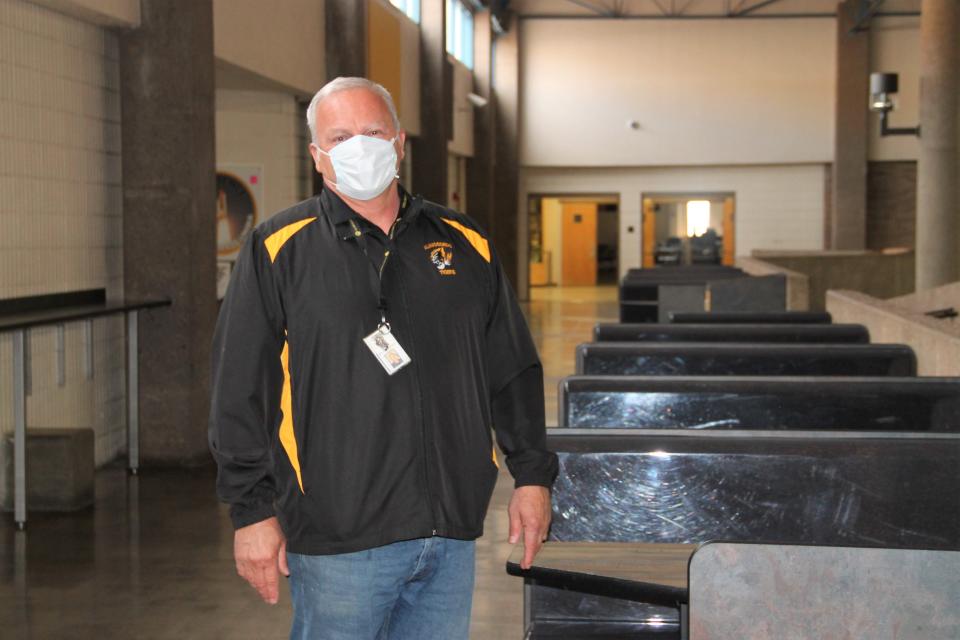 Then-Alamogordo High School Principal Ken Moore stands near empty tables in the AHS Commons area in December 2020.