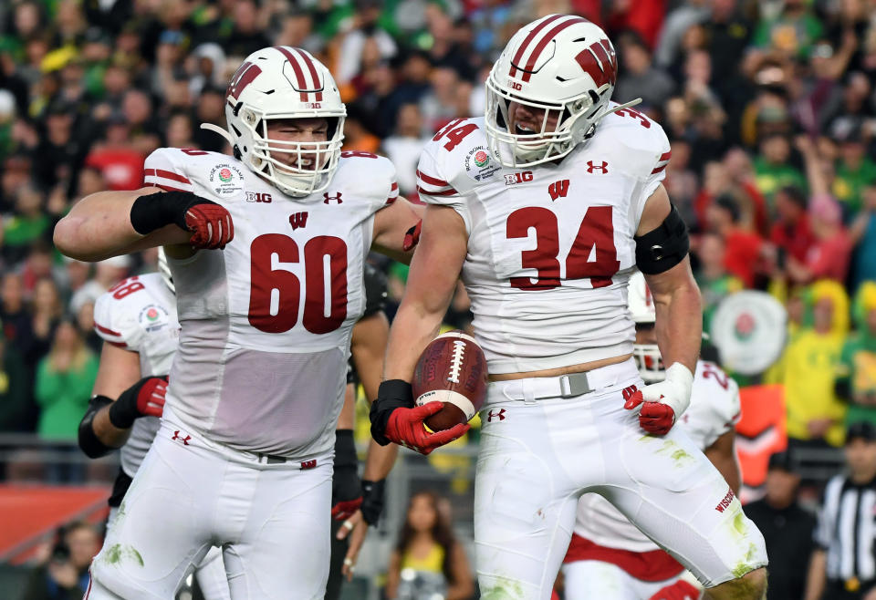 Jan. 1, 2020; Pasadena, California; Wisconsin Badgers fullback Mason Stokke (34) celebrates with offensive lineman Logan Bruss (60) after scoring a touchdown against the Oregon Ducks in the third quarter during the 106th Rose Bowl game at Rose Bowl Stadium. Kirby Lee-USA TODAY Sports