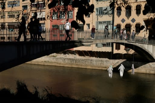 Under a bridge over the Onyar River, three makeshift dummies have been 'hanged', each emblazoned with a different word: "democracy", "freedom" and "the right to protest"