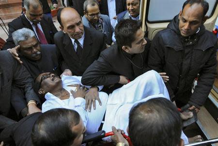 K Narayana Rao, a parliamentarian, is rushed to a hospital after he collapsed inside the parliament in New Delhi February 13, 2014. REUTERS/Adnan Abidi