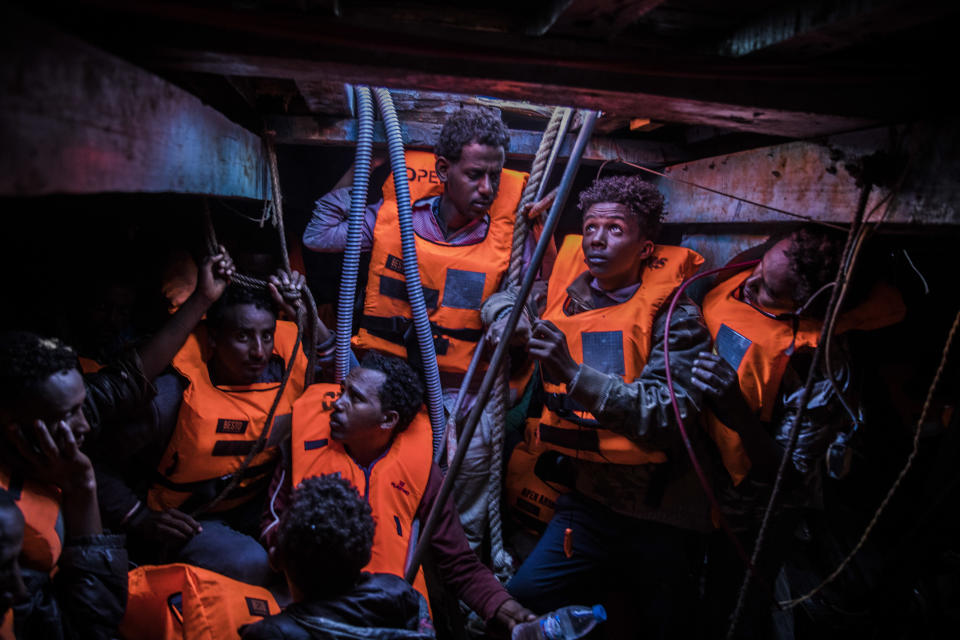 FILE - In this Tuesday Jan. 16, 2018 file photo sub-Saharan refugees and migrants, mostly from Eritrea, wait to be rescued by aid workers of Spanish NGO Proactiva Open Arms, in the lower deck of a wooden as they were trying to leave the Libyan coast and reach European soil, 34 miles north of Kasr-El-Karabulli, Libya. (AP Photo/Santi Palacios, File)