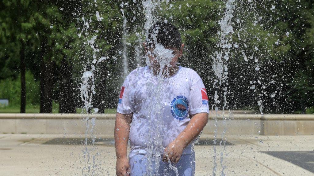 A child cools off in a park in Houston, Texas on a hot day in July 