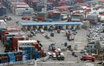 Trucks move into a port in Busan, on the day truckers voted to end a nationwide strike