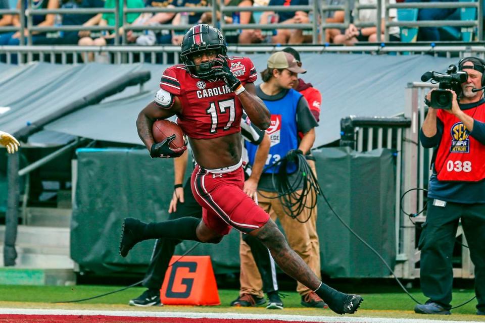 South Carolina wide receiver Xavier Legette (17) runs the ball in for a touchdown after a catch during the first quarter of the Gator Bowl NCAA college football game against Notre Dame on Friday, Dec. 30, 2022, in Jacksonville, Fla. (AP Photo/Gary McCullough)