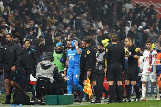 Marseille’s Dimitri Payet leaves the pitch after being hit by a bottle 