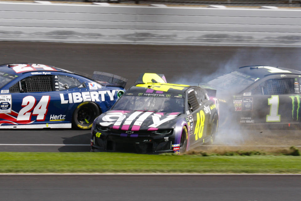 NASCAR driver Jimmie Johnson (48) makes contact with Kurt Busch (1) in the second turn during the NASCAR Brickyard 400 auto race at the Indianapolis Motor Speedway, Sunday, Sept. 8, 2019, in Indianapolis. (AP Photo/Bud Cunningham)