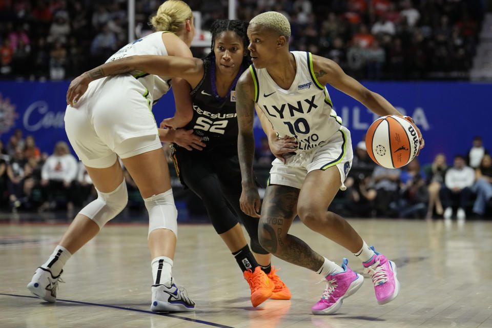 UNCASVILLE, CONNECTICUT – OCTOBER 4: Courtney Williams #10 of the Minnesota Lynx drives past Tyasha Harris #52 of the during the second half of Game 3 of the WNBA Playoff Semifinals at Mohegan Sun Arena on October 4, 2024 in Uncasville, Connecticut Connecticut Sun over. The Lynx defeated the Sun 90-81. NOTE TO USER: User expressly acknowledges and agrees that by downloading and/or using this photograph, User is agreeing to the terms and conditions of the Getty Images License Agreement. (Photo by Joe Buglewicz/Getty Images)